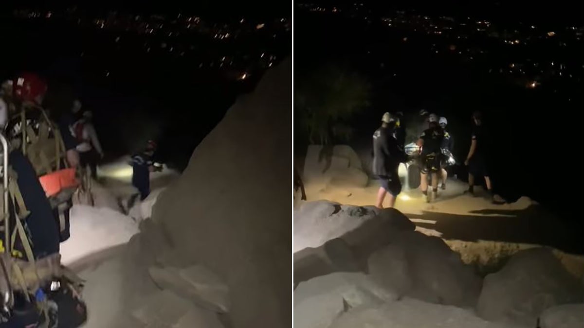 rescuers helping woman down park trail