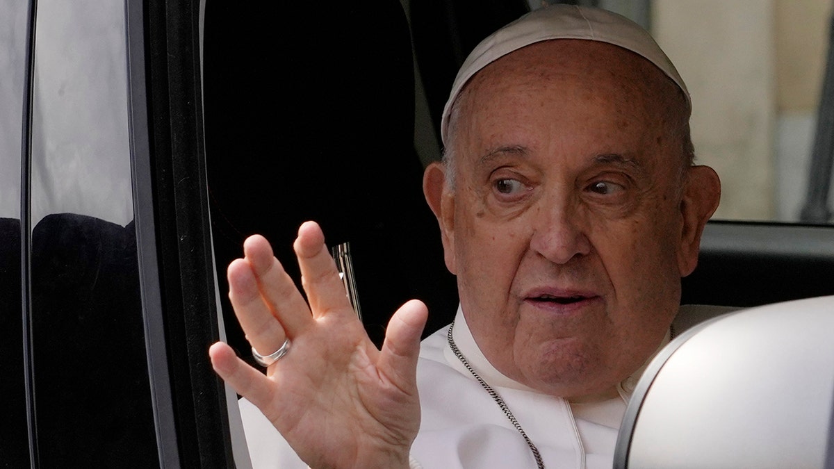 Pope Francis waves after leaving hospital