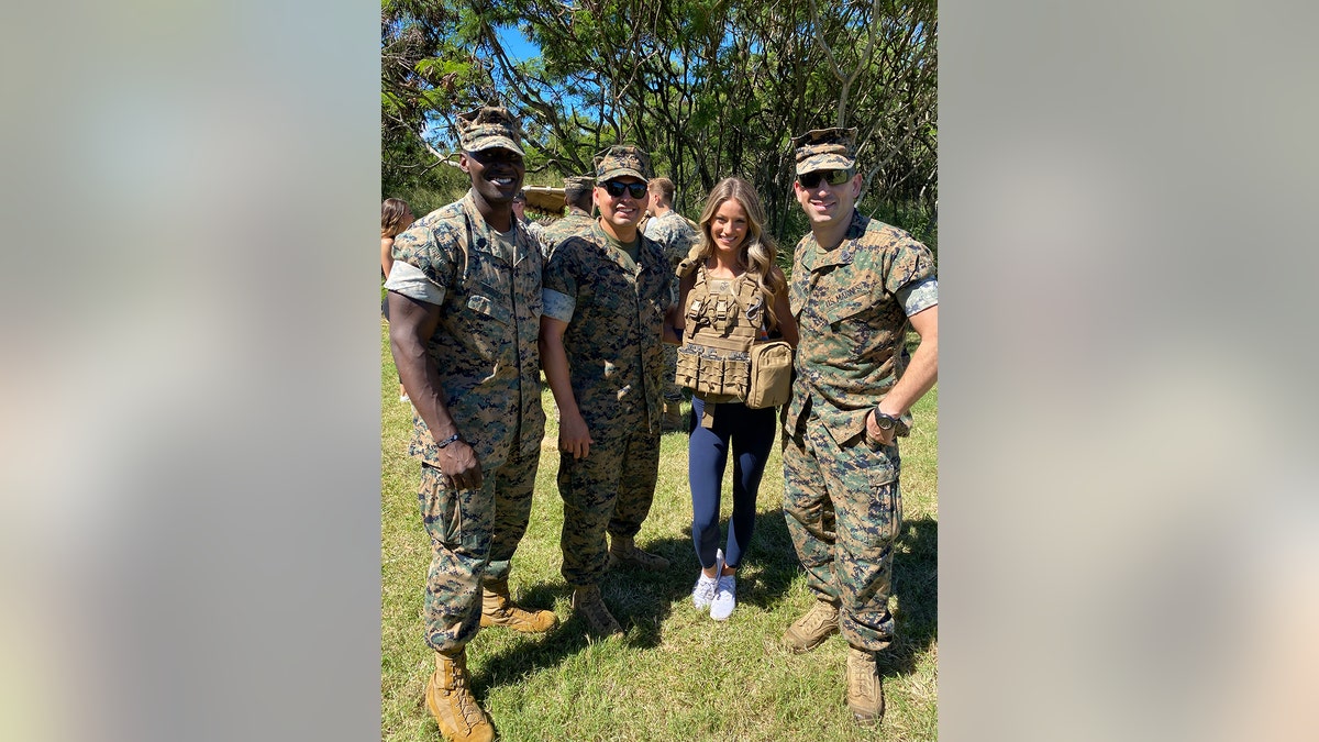 Berkleigh Wright posing for a photo with military servicemen