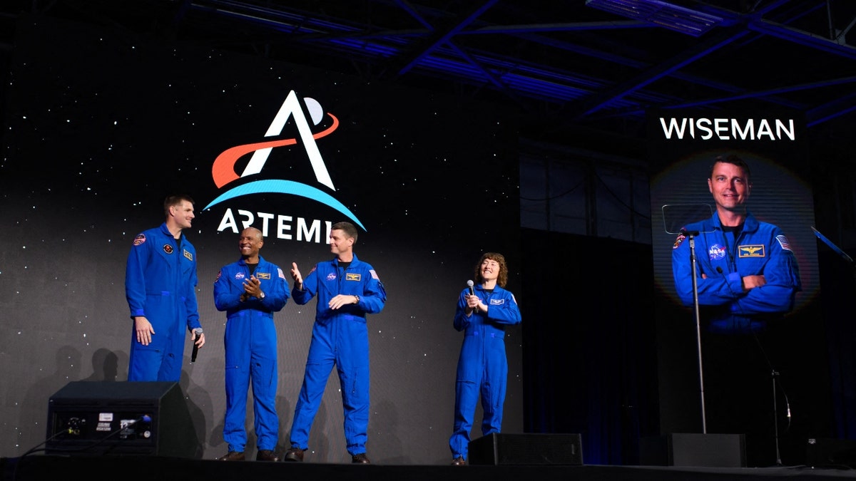 The Artemis II astronauts on a stage