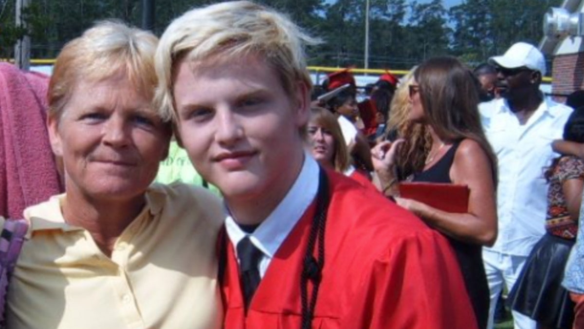 Stephen Smith and his mother, Sandy Smith, pose in a graduation photo.