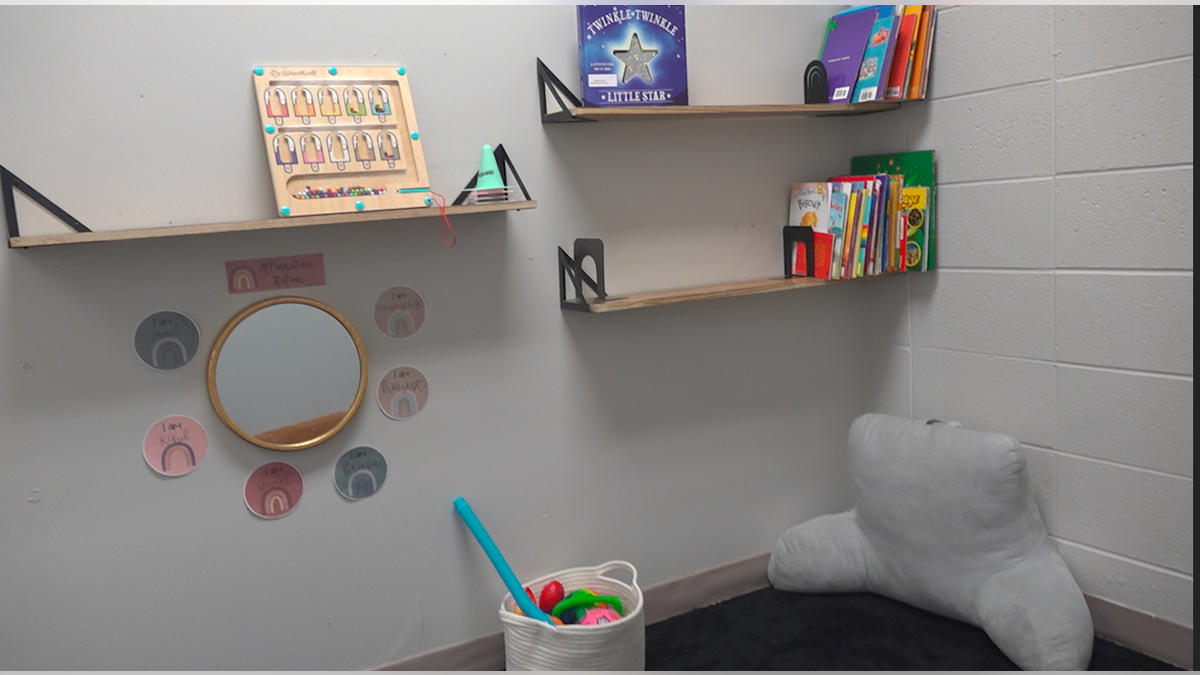 Inside the safe room with children's toys, books and pillows