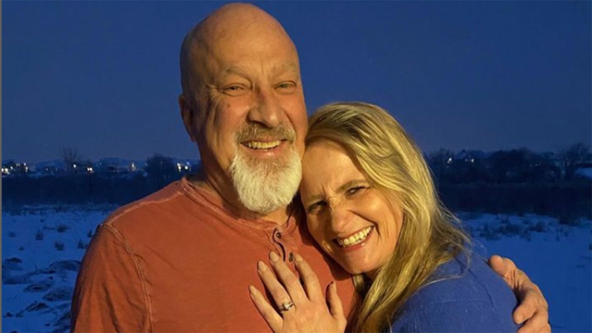 Sister Wives star Christine Brown showing off her engagement ring, in a picture with her new fiance