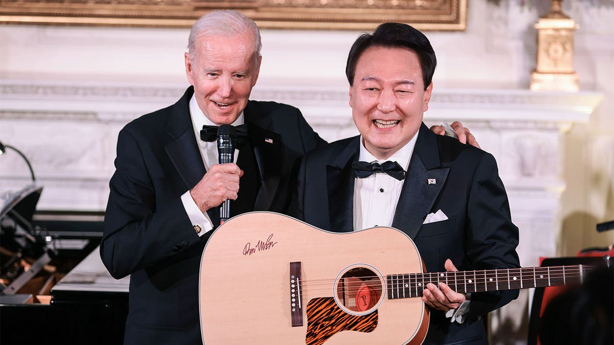 Yoon Suk Yeol, South Korea's president, holds a guitar 