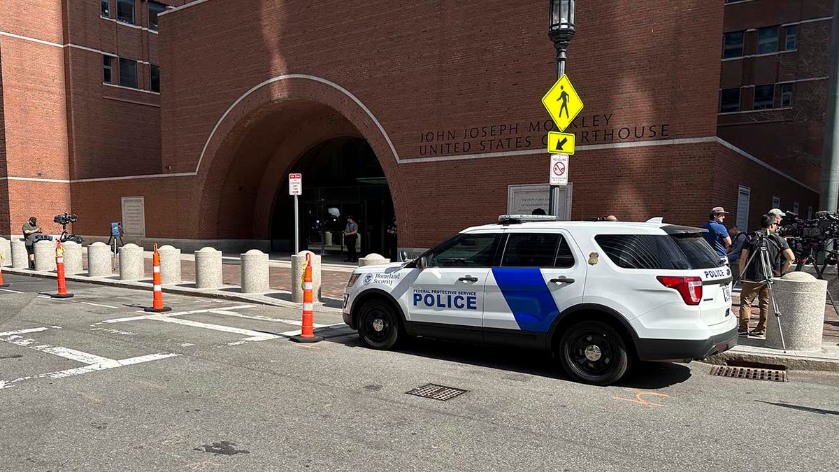 A federal police vehicle is parked outside U.S. District Court