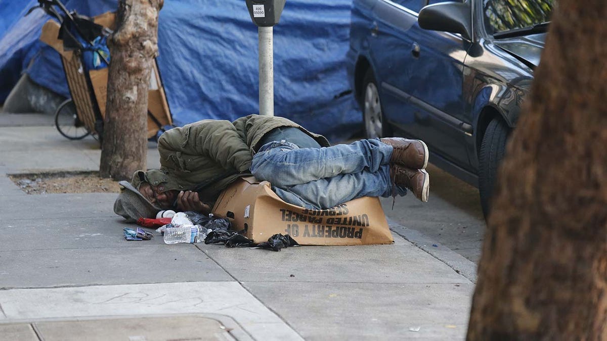 Homeless persons are seen sleeping on the street of Tenderloin during the state of emergency.