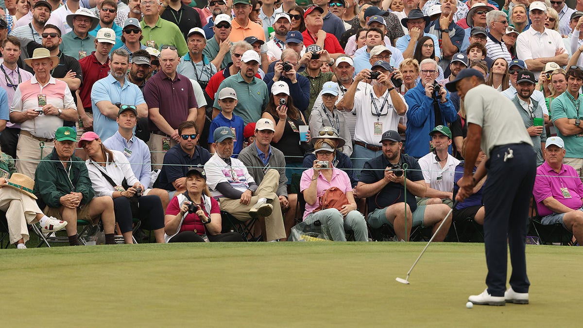 Patrons look on as Tiger Woods plays at The Masters