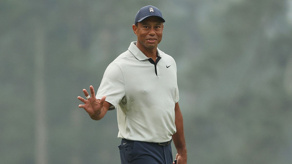 Tiger Woods waves
