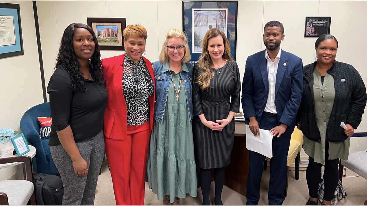 North Carolina state Rep. Tricia Cotham, third from right, after discussion with parents from Charlotte on education.