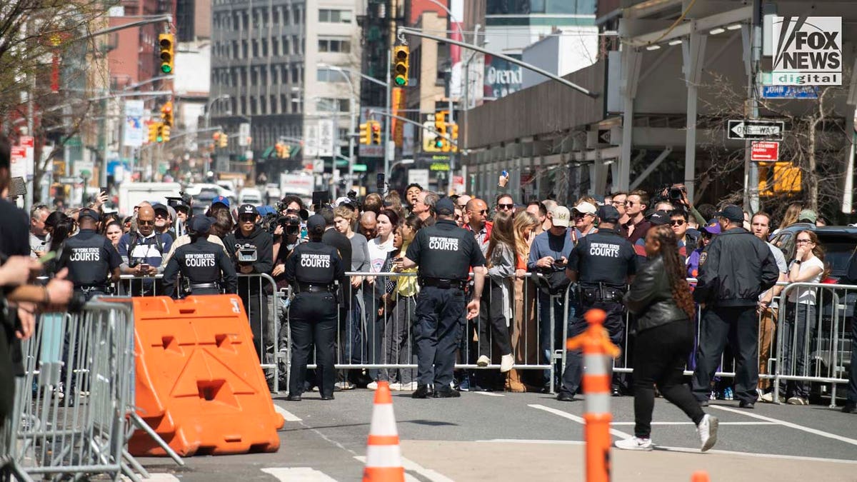 Spectators line the streets outside of the Manhattan Criminal Courthous