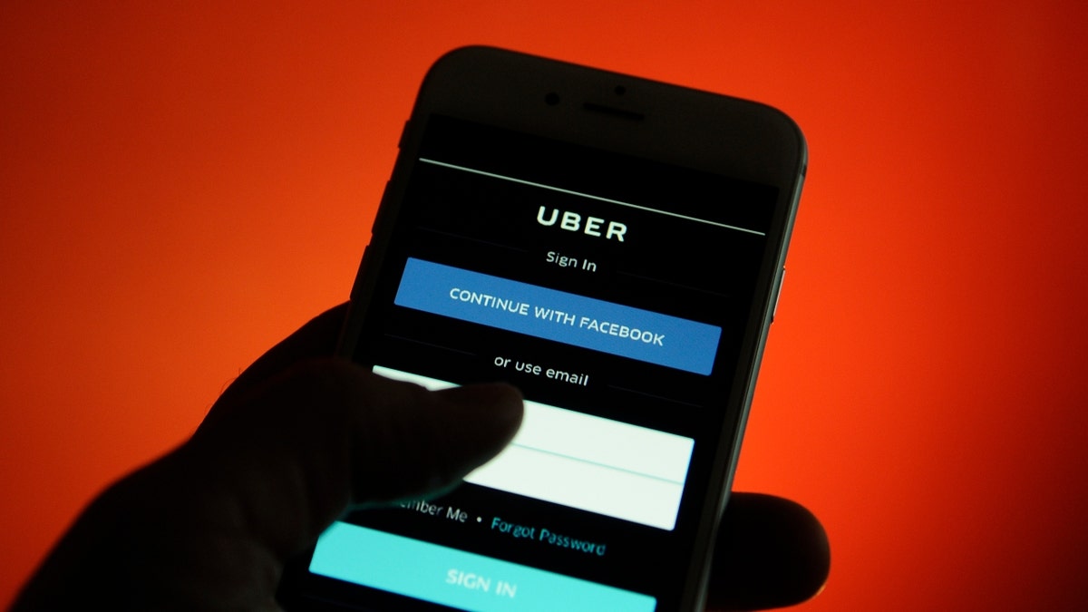 An iPhone with an Uber application login screen