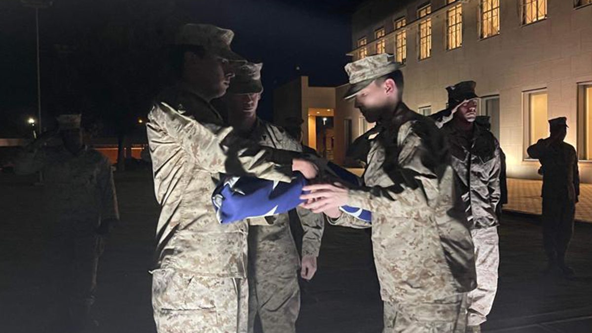 US Marines fold flag at US Embassy in Khartoum, Sudan