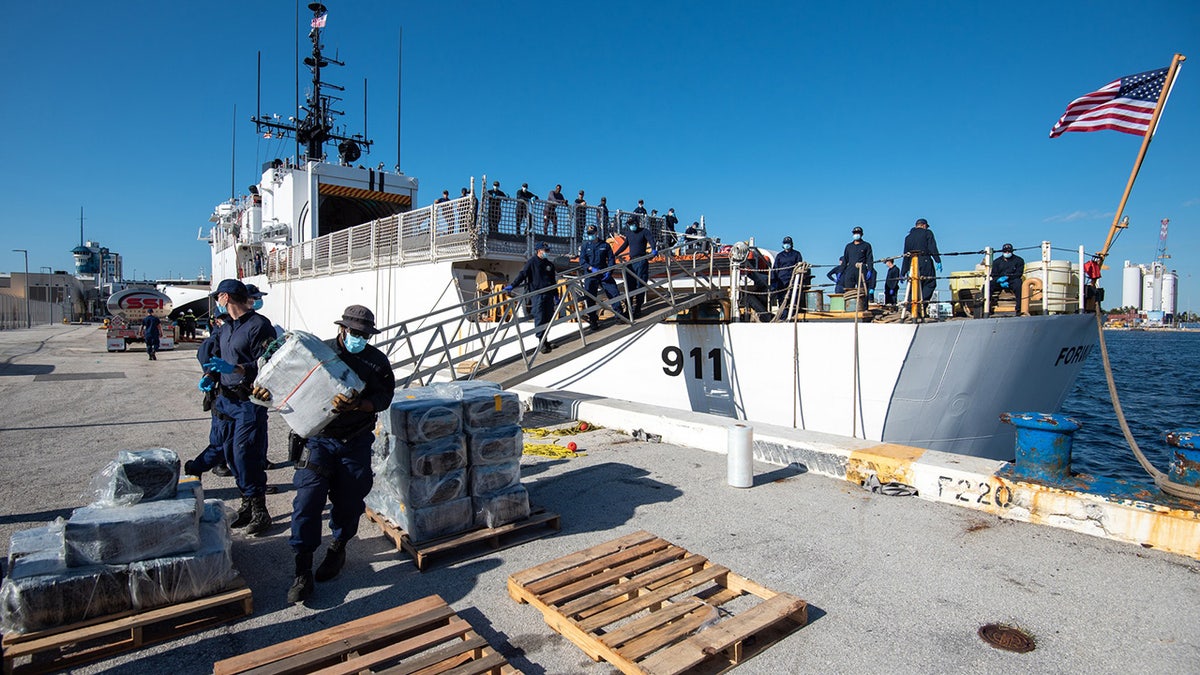 crews stacking bales of cocaine