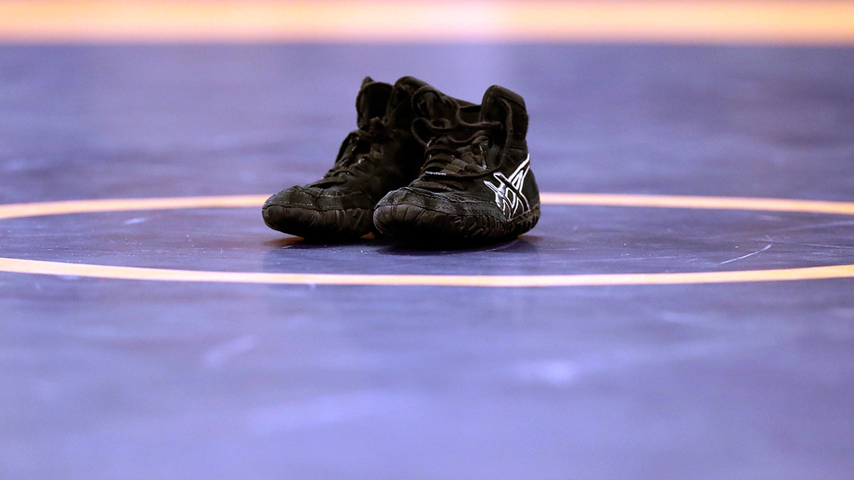 Shoes sit on wrestling mat in Iowa