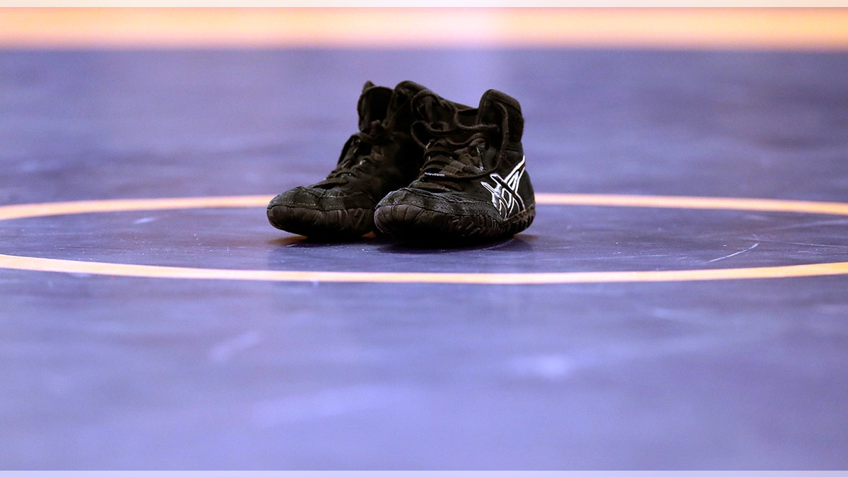 Shoes sit on wrestling mat