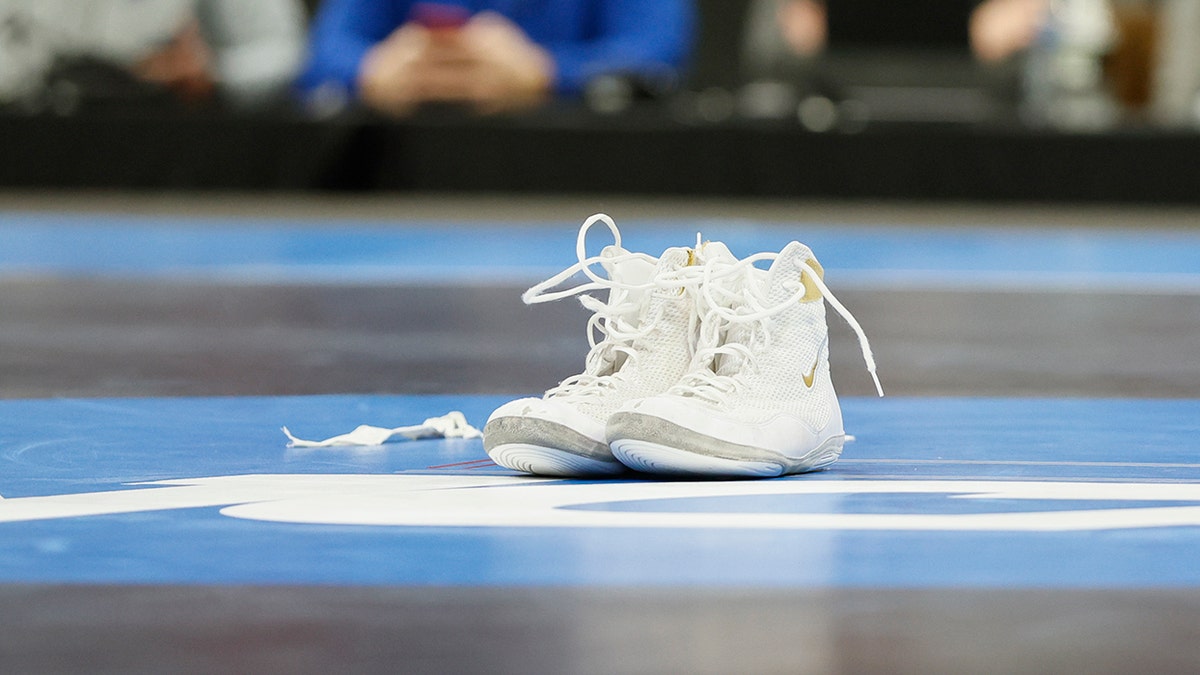 Wrestling shoes sit on mat