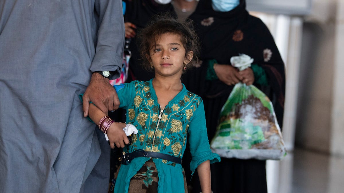 Afghan refugees arrive to Dulles International Airport on Friday, August 27, 2021