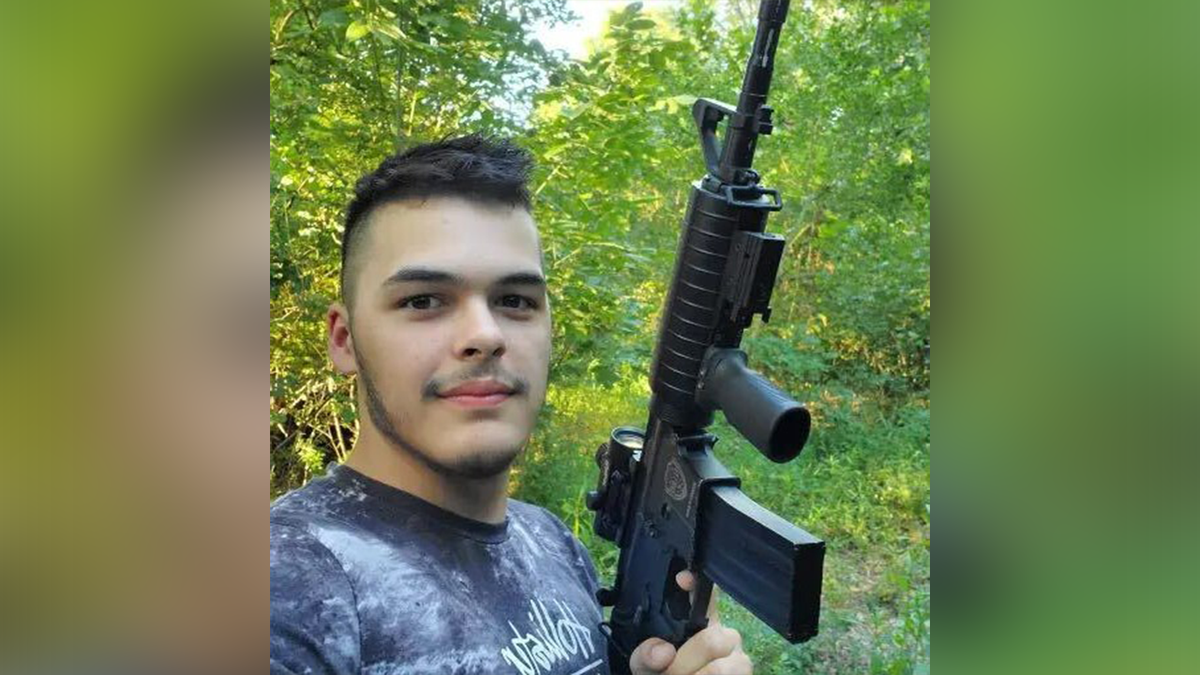 Josiah Ernesto Garcia holding a gun