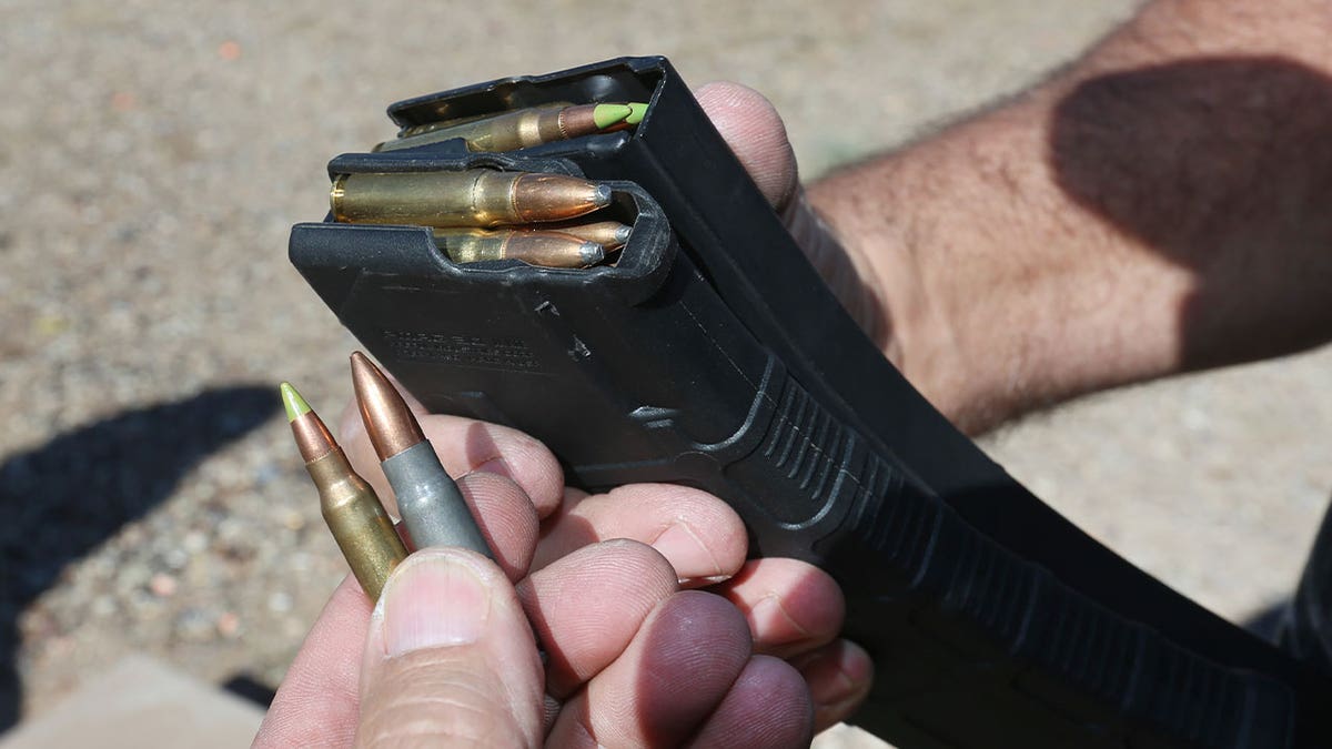 Man loads bullets into high-capacity magazine