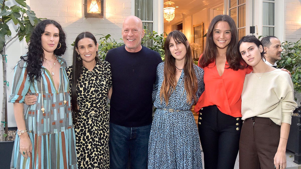 Bruce Willis poses with his ex-wife and their three daughters and new wife Emma Heming Willis at Demi Moore's book launch