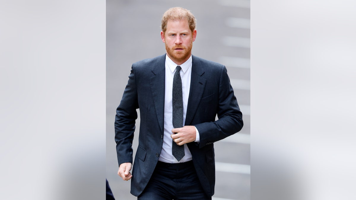 Prince Harry in a navy suit and tie