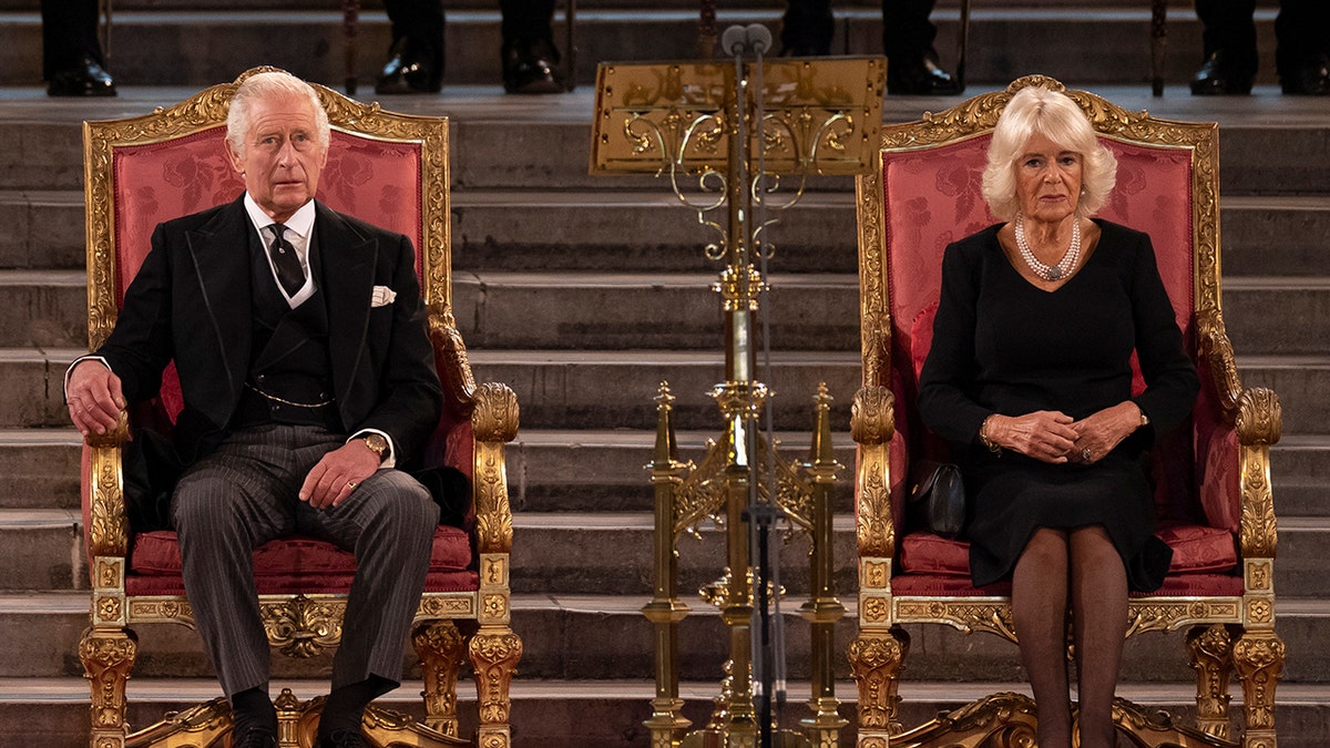 King Charles and Camilla, the queen consort sitting.