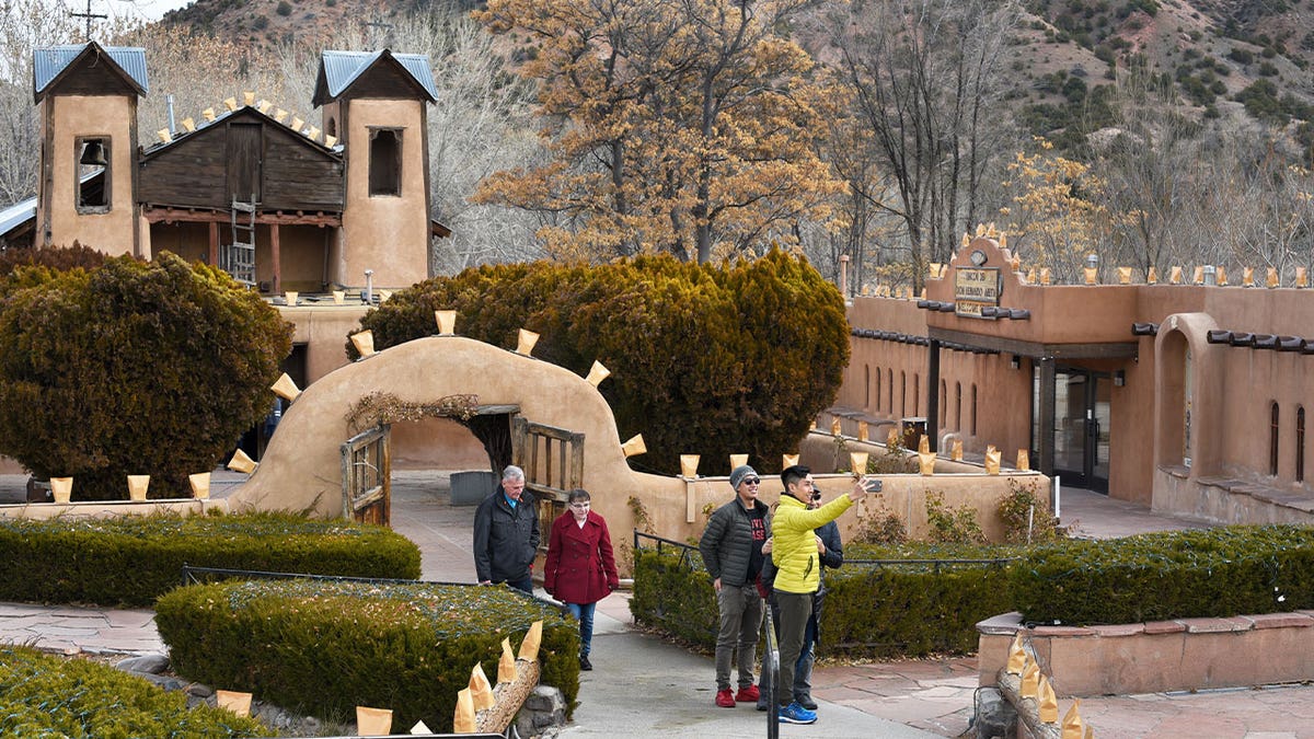 People visit El Santuario de Chimayó near Santa Fe, New Mexico, on Dec. 24, 2019. Thousands of Catholics are making the trek to the historic site, which is one of the most important Catholic pilgrimage centers in the U.S.