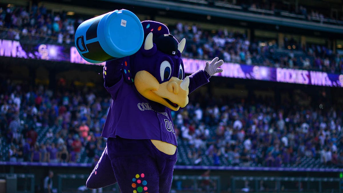 Colorado Rockies mascot Dinger interacts with fans prior to a