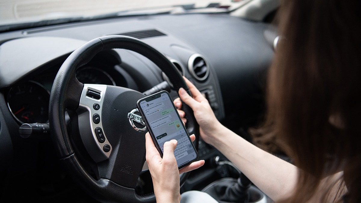 woman texting while driving