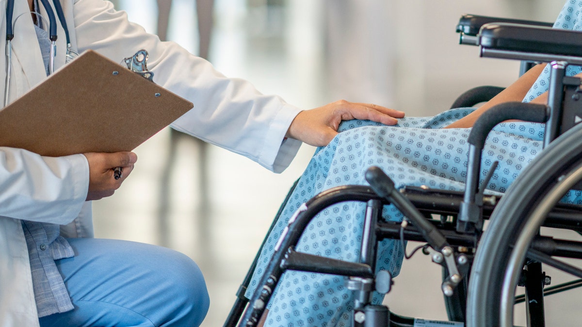 Doctor with patient in wheelchair