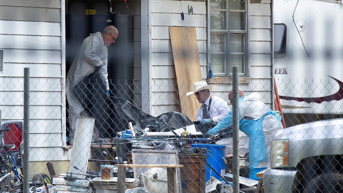 Investigators take items out of Cleveland, Texas, shooting scene