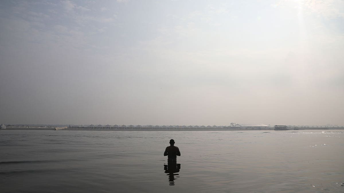 Man prays in Ganges River