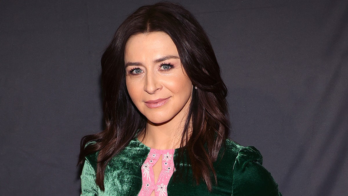 Caterina Scorsone walks red carpet wearing a green velour dress with pink lace