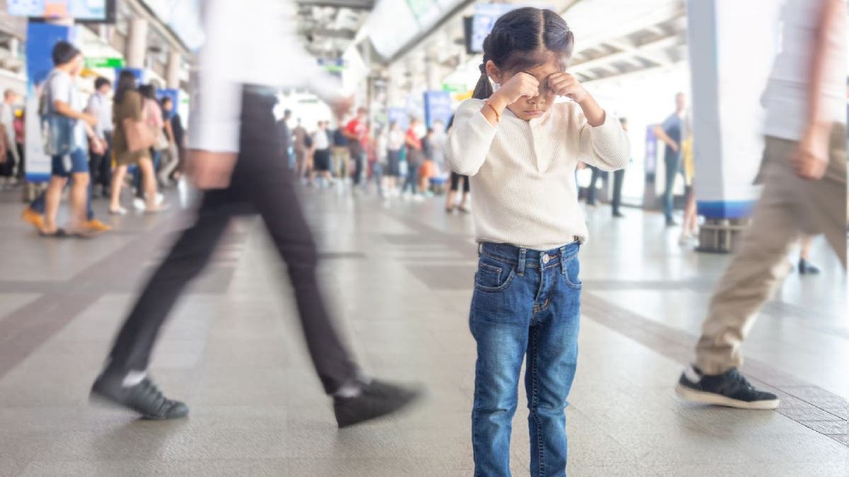 Lost girl crying in busy train station