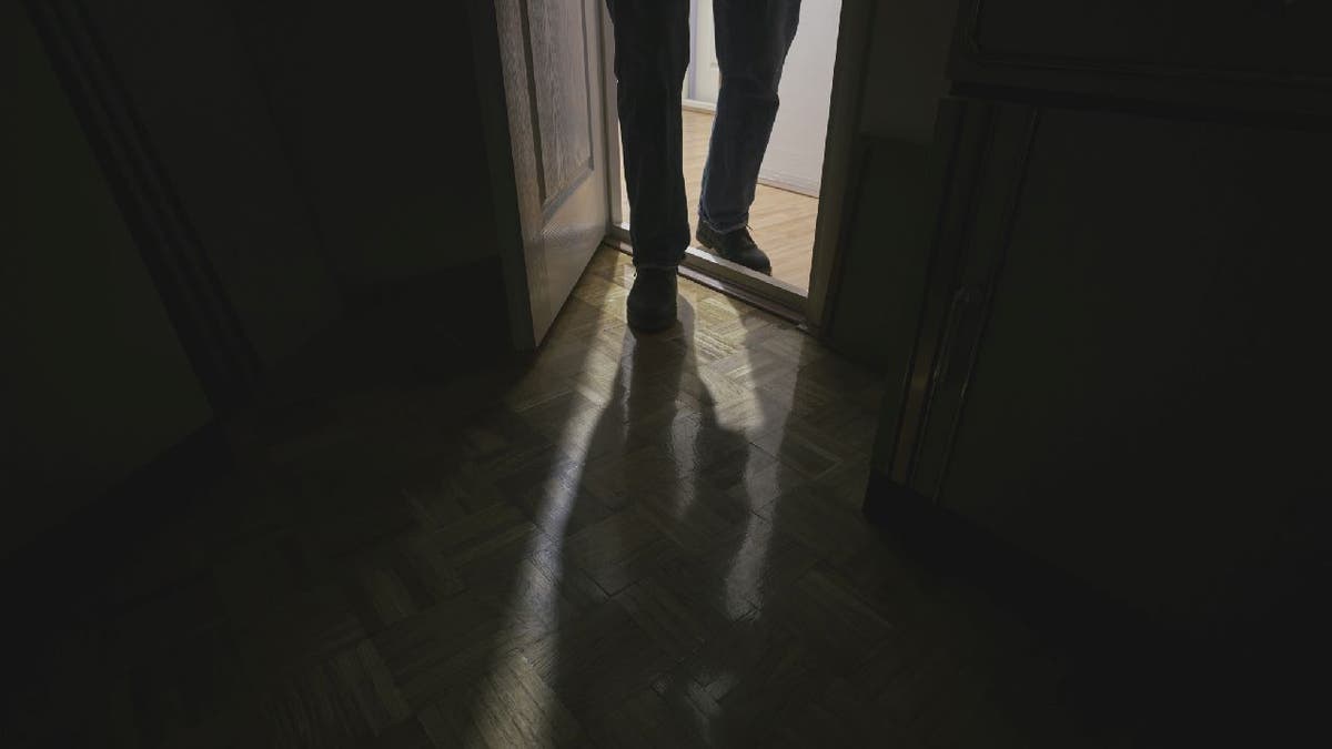 Man enters dark room