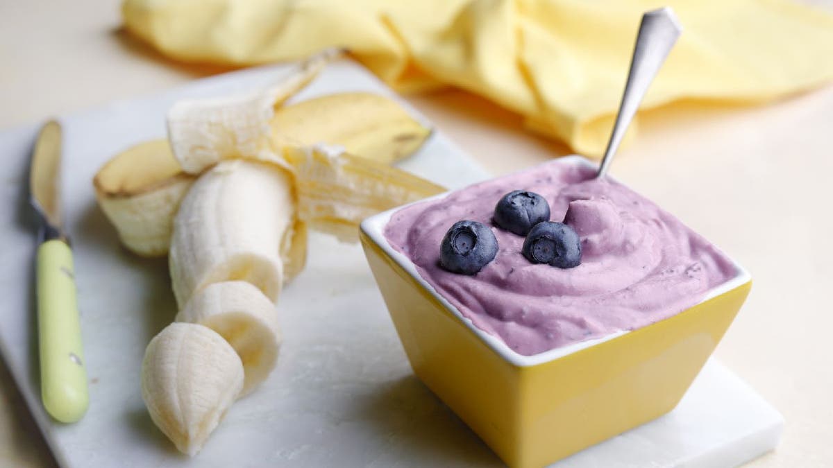 Blueberry ice cream served next to sliced bananas