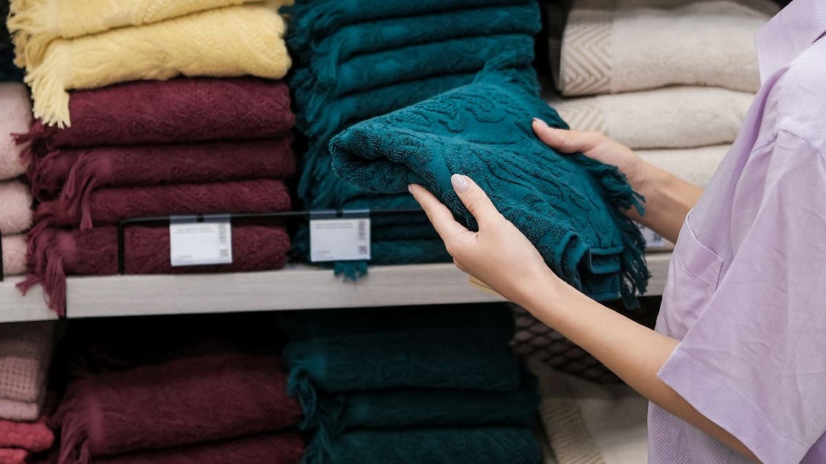 Person looks at towels in a store