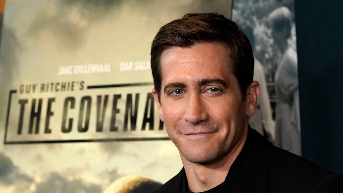 Jake Gyllenhassl in front of "The Covenant" psoter