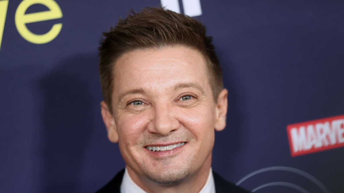 Jeremy Renner flashes a smile at the "Hawkeye" premiere.