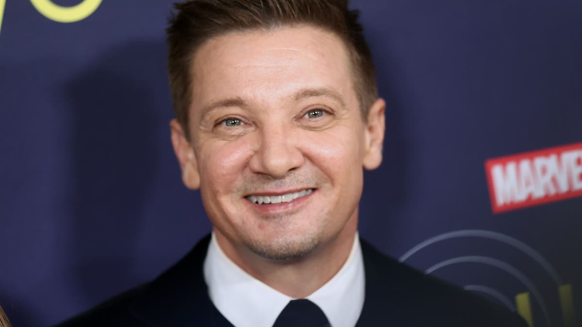 Jeremy Renner flashes a smile at the "Hawkeye" premiere.