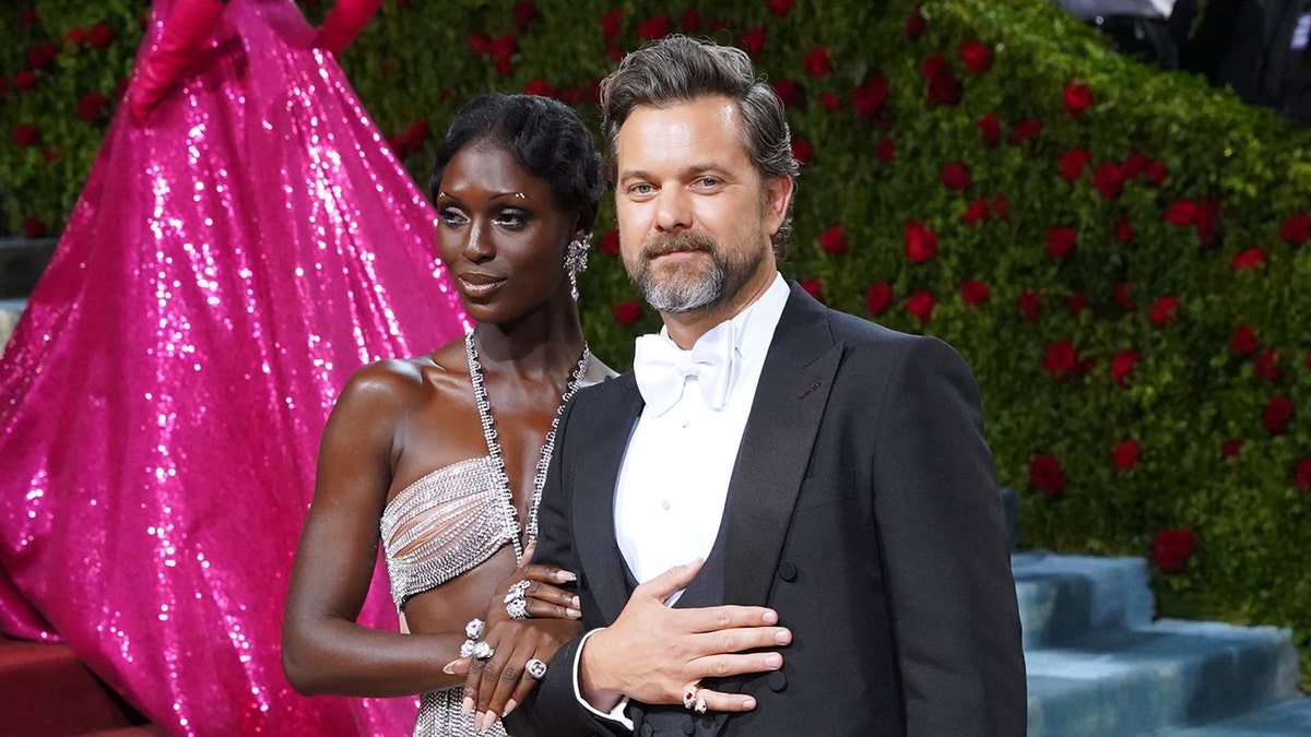Jodie Turner Smith and Joshua Jackson on a red carpet smiling
