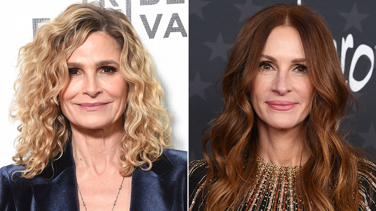 Kyra Sedgwick in a satin blue blazar soft smiles on the red carpet with curly blonde hair split Julia Roberts with dark brown hair on the red carpet wearing sparkly embellishments