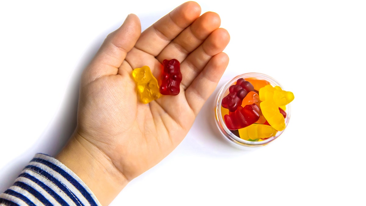 Kid's hand with gummies