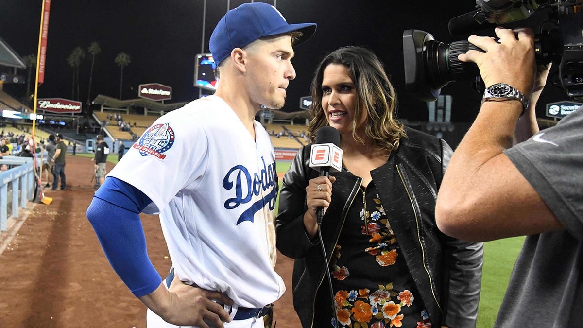 Los Angeles Dodgers shortstop Kike Hernandez is interviewed by ESPN Deportes broadcaster Marly Rivera after the game against the Chicago Cubs at Dodger Stadium. The Dodgers defeated the Cubs 2-1.