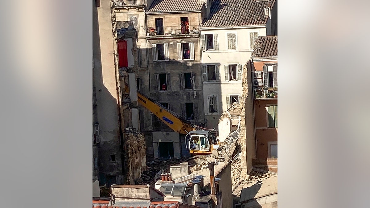 excavator clearing rubble