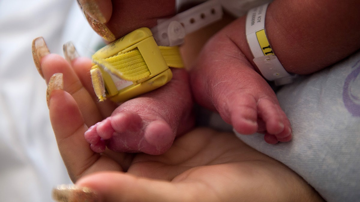 Close up of a mother holding her baby in the hospital