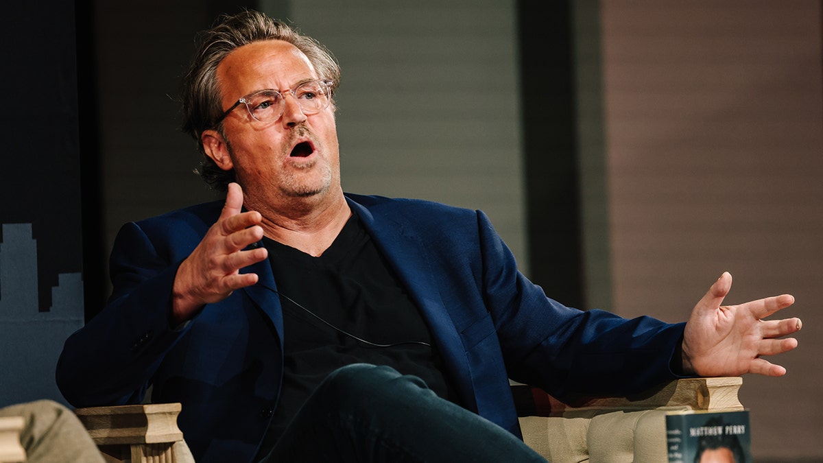 Matthew Perry wears blue blazer with black shirt and jeans at panel discussion