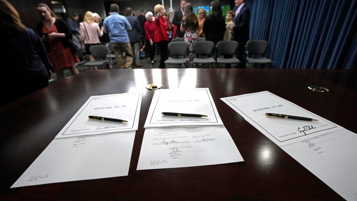 An official gubernatorial pen rests on each of the three bills signed by Mississippi Gov. Tate Reeves