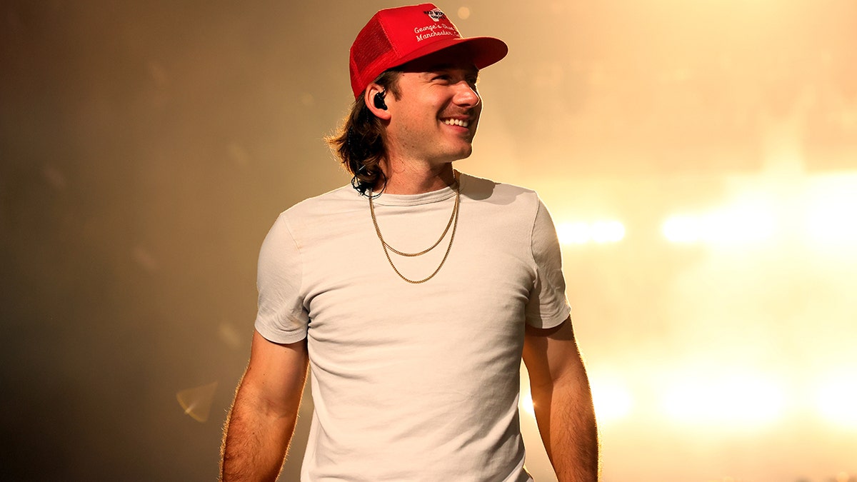 Morgan Wallen smiles on stage during a concert