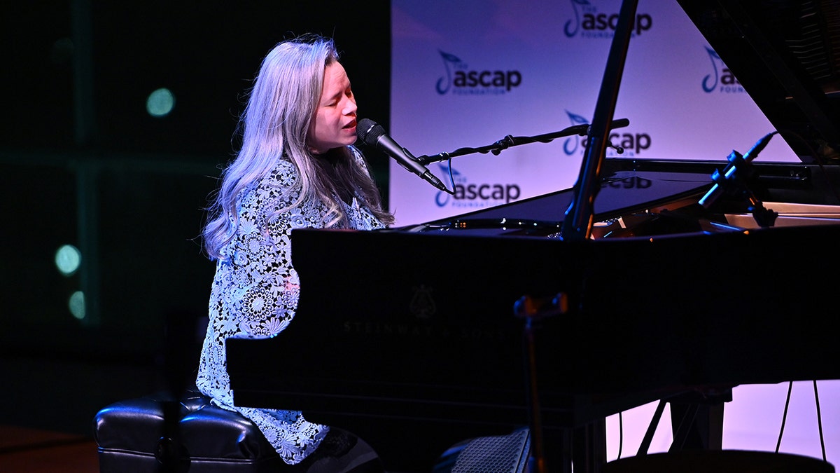 Natalie Merchant singing and playing the piano